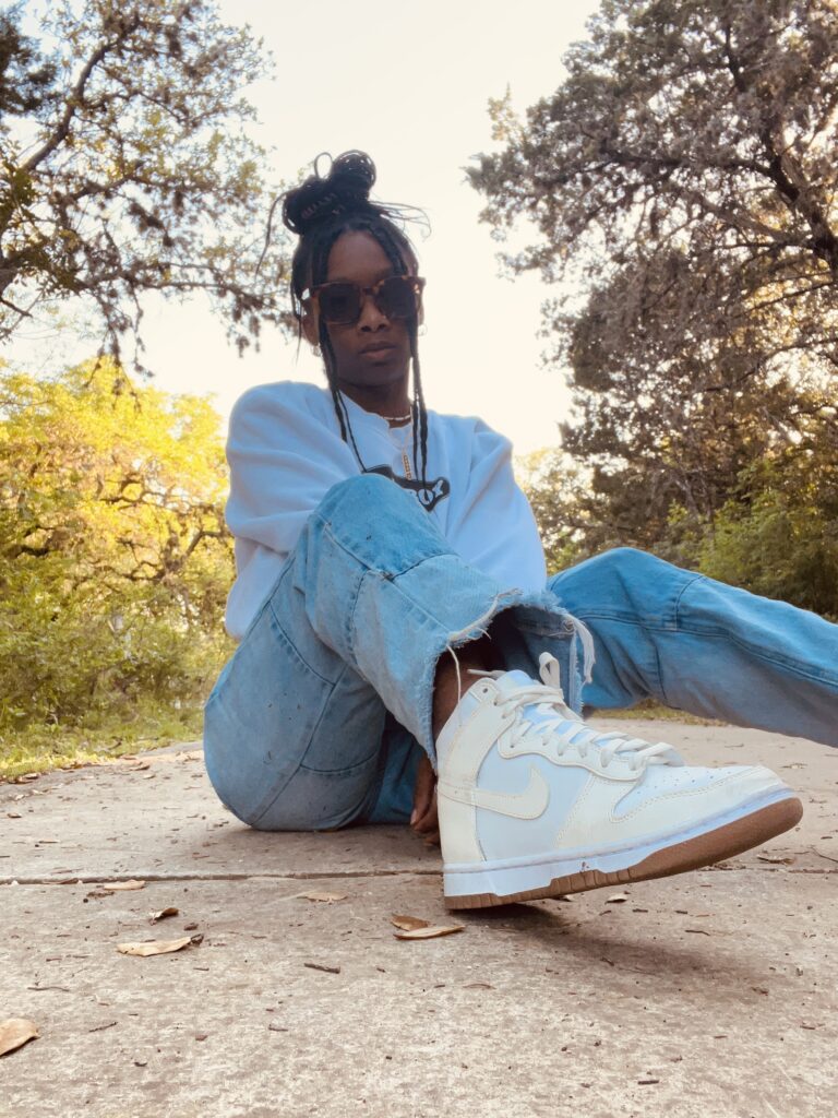 an image of vanessa reid sitting on the ground outside